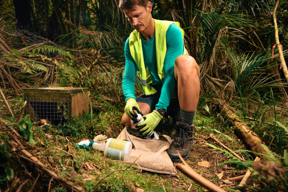 Photo of man setting up a trap in a forest