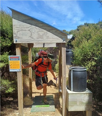 Man cleans shoe in hygiene station