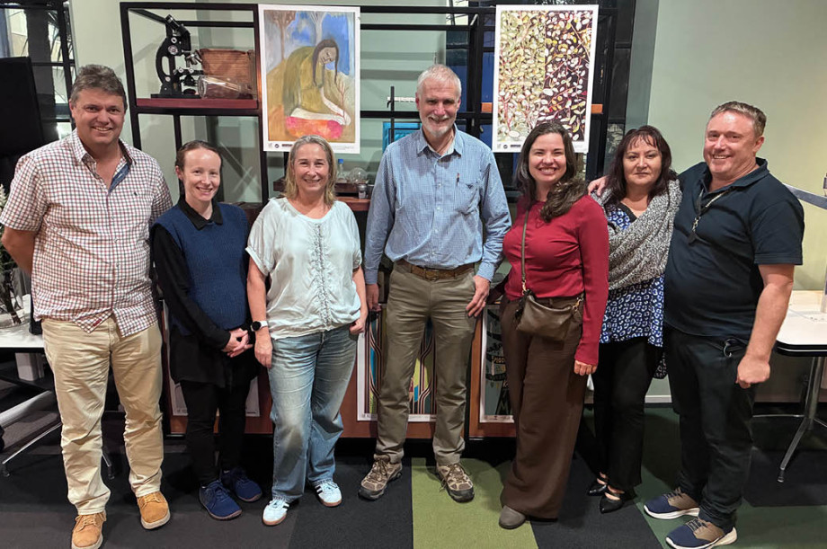 Kauri science community stand in a line